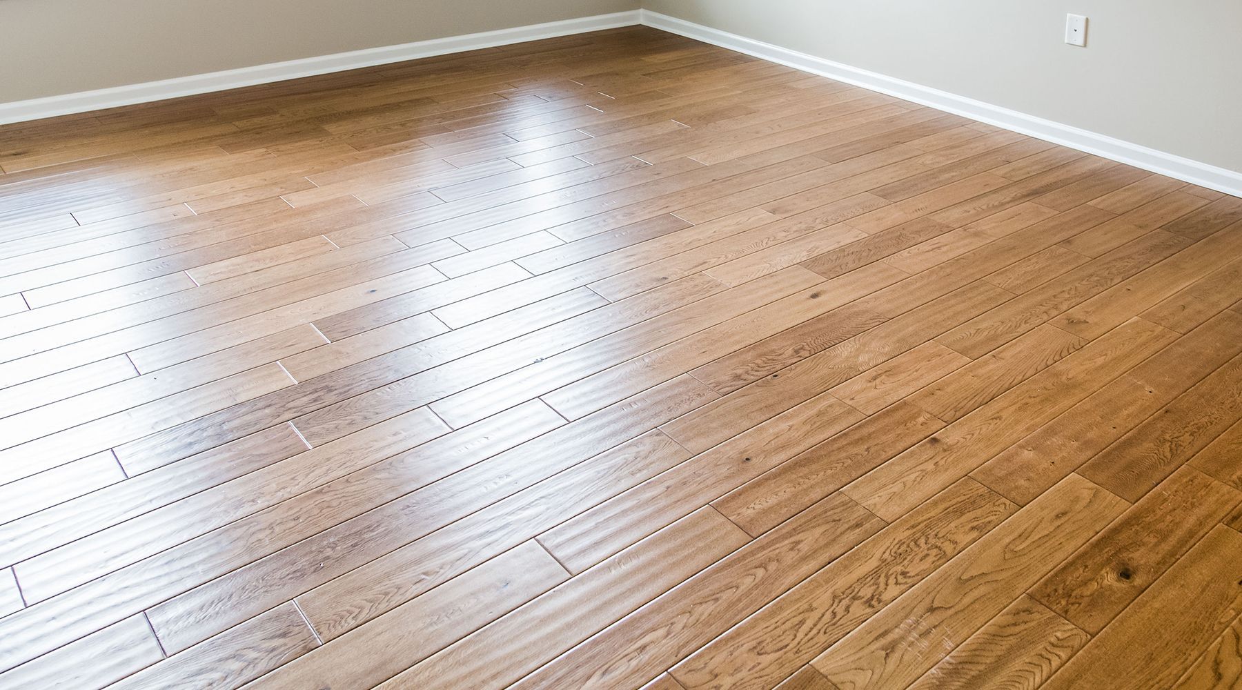 Freshly installed hardwood flooring in a bright living room